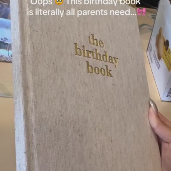 The Birthday Book heirloom keepsake journal with linen cover and gold foil lettering · The Birthday Book open to a birthday memory page with writing prompts · The Birthday Book interior pages showing letter and memory sections · The Birthday Book premium keepsake journal for recording 18 years of birthdays · The Birthday Book linen cover detail with gold accent lettering · The Birthday Book lay-flat binding for easy writing. The Birthday Book archival acid-free pages for lasting memories · The Birthday Book